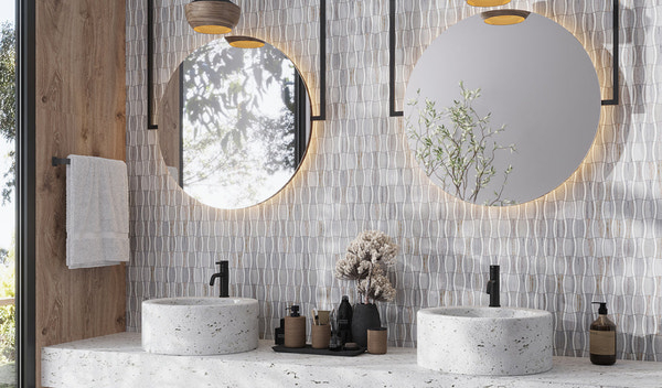 modern bathroom with dual round illuminated mirrors and light gray textured backsplash tile