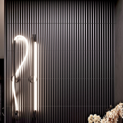 Matte black 12x36 fluted ceramic tiles in vertical arrangement for modern interior walls