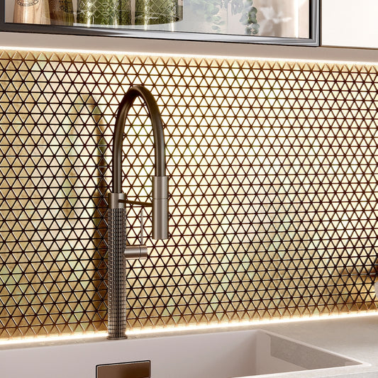 Glossy shimmer gold triangle glass mosaic tile backsplash with uniform geometric pattern