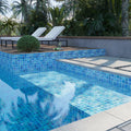 Glossy blue glass mosaic tiles 12x12 inches installed on a swimming pool surface and walls