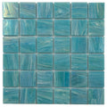 Glossy light teal blue square glass mosaic tile sheet with varied blue swirls and shine