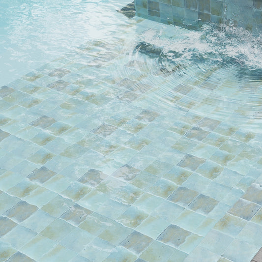 sky blue 6x6 glossy zellige square porcelain tile submerged in water with reflective surface