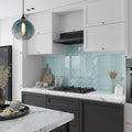 glossy light blue 3x12 glass subway tile backsplash in kitchen with herringbone and horizontal patterns