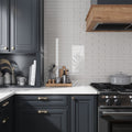 Warm greige 3x12 glossy glass subway tile used as kitchen backsplash wall tile