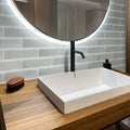 Gray 3x12 matte glass subway tile on bathroom wall