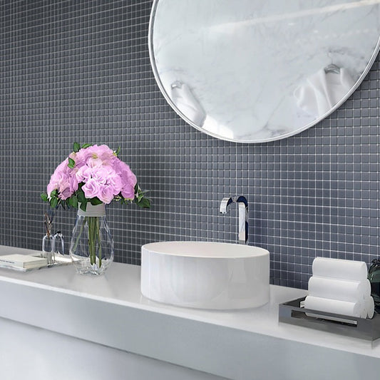 Coin gray matte glass mosaic tile, square 1x1 inch, installed on bathroom wall