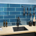 Cerulean blue glossy glass subway tile 4x16 inch installed as kitchen backsplash