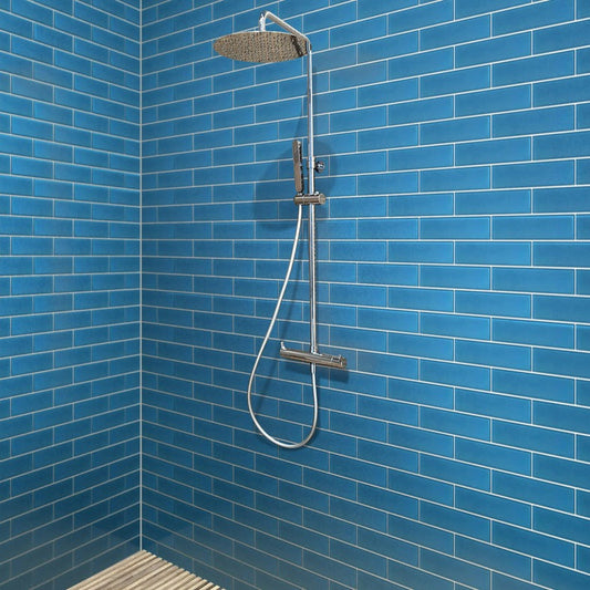 Cerulean blue 3x12 matte glass subway tile installed on shower walls