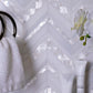 pearl white polished thassos shell herringbone mosaic tile in 12x12 size with reflective surface