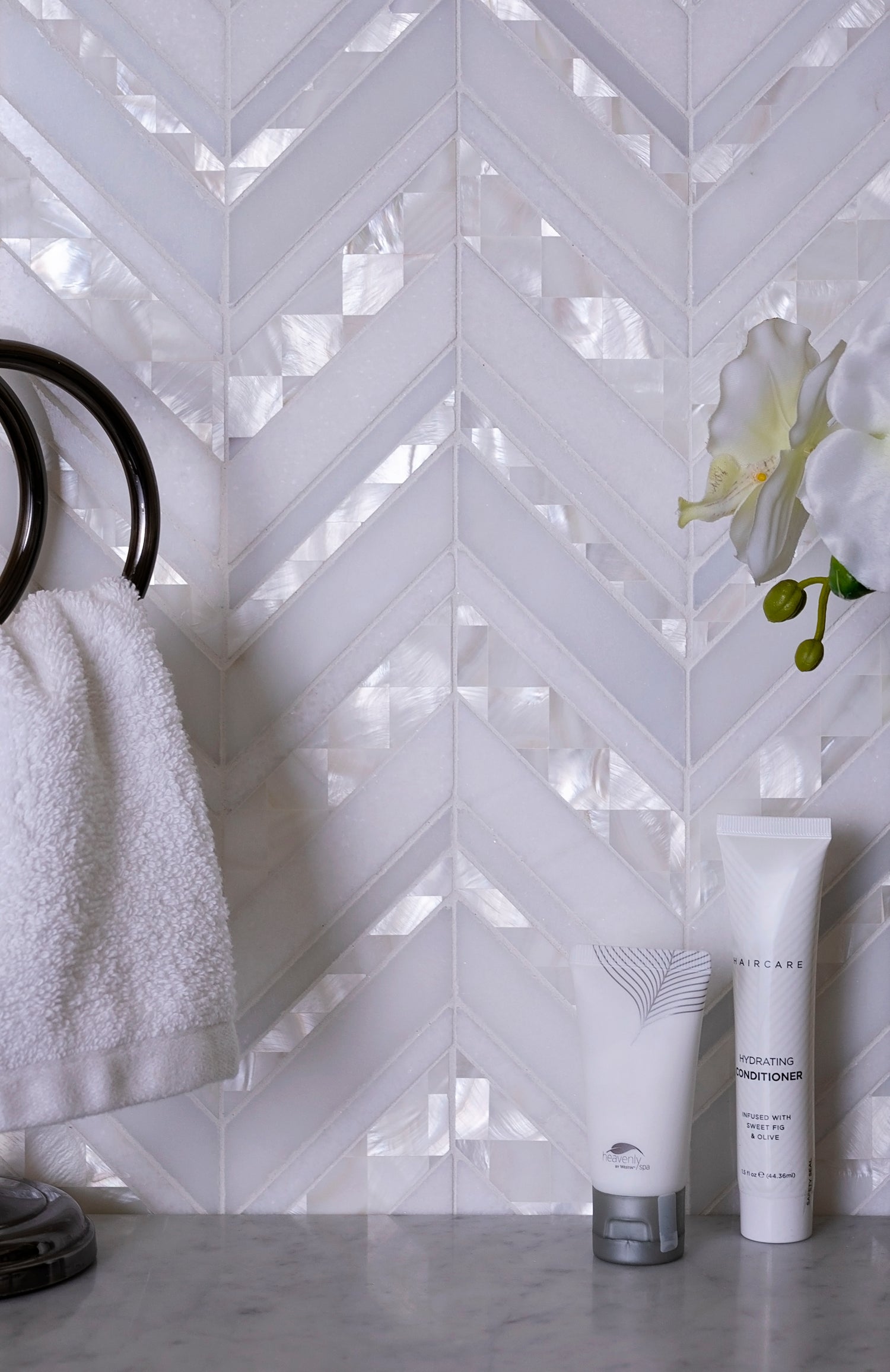 pearl white polished thassos shell herringbone mosaic tile in 12x12 size with reflective surface