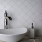 Pearl white polished Thassos shell hexagon mosaic tile with small square accents in light gray grout