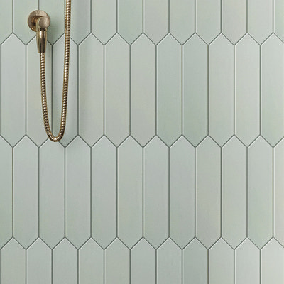 Tea green matte ceramic picket tile 2x10 used on shower wall with metallic shower fixture