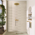 Beige matte ceramic picket tile 2x10 installed on shower wall with gold shower fixtures