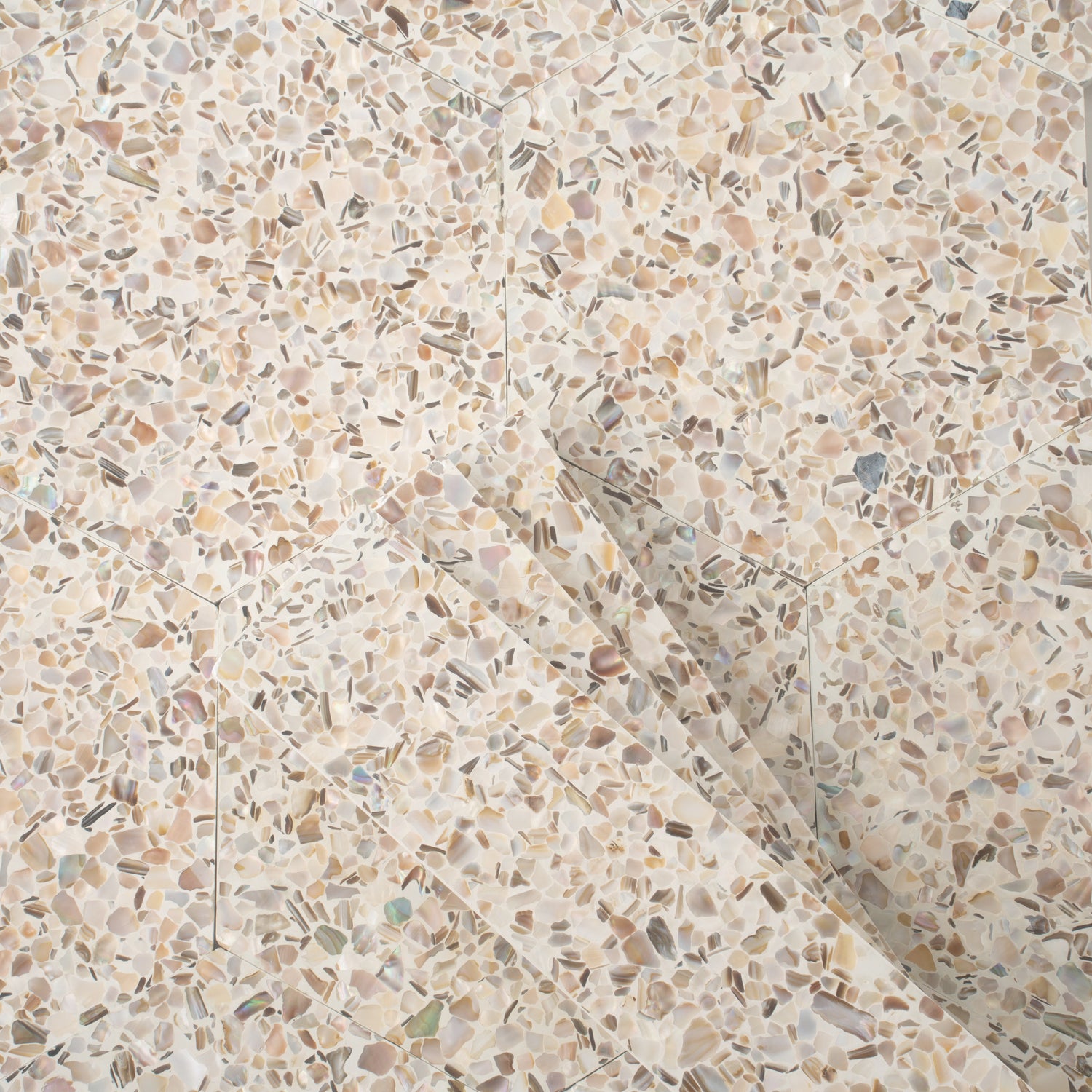 Glossy ivory white terrazzo hexagon tile with copper flecks and shell pieces, 9x8 inches