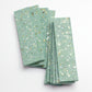 mint green terrazzo elongated subway tile with copper and shell flecks 3x12 glossy finish