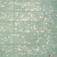 Mint green terrazzo elongated subway tile with glossy finish and copper flecks 3x12 inches