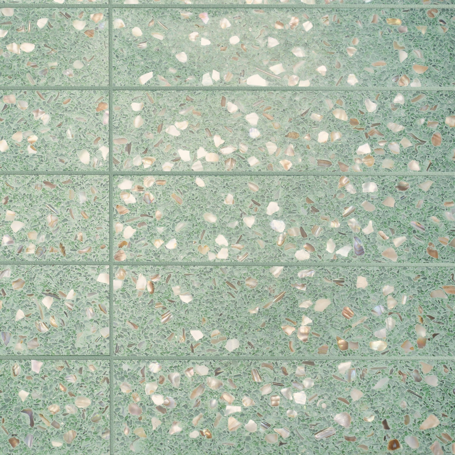Mint green terrazzo elongated subway tile with glossy finish and copper flecks 3x12 inches