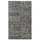 Glossy black terrazzo subway tile with amber pearl flecks in 3x12 elongated shell shape