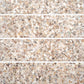 Glossy 3x12 ivory white terrazzo shell tile with copper flecks and elongated subway shape