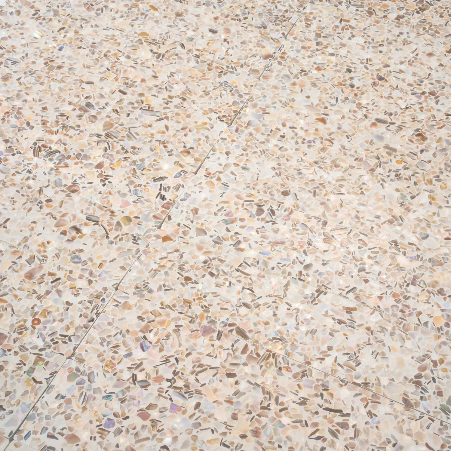 Glossy ivory white terrazzo elongated subway tile with copper flecks 3x12 shell pattern