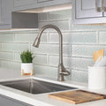 Pearl white 3x12 textured glossy glass subway tile installed as kitchen backsplash