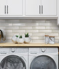 Glossy white glass mosaic tile backsplash in 12x12 inch subway pattern for kitchen or laundry walls