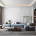 Soft white matte ceramic large format tile with gold and grey veins on a living room wall