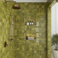 Olive green 4x4 glossy ceramic tiles on shower wall with built-in niches