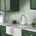 Tea green glossy ceramic subway tile 2.6x16 inches installed as kitchen backsplash wall