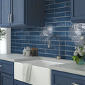 Glossy navy blue ceramic rectangular subway tiles on kitchen backsplash wall