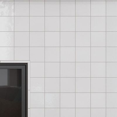Glossy ivory white 4x4 ceramic square tiles installed on interior wall surface