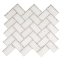 polished white bianco carrara and thassos marble mosaic tiles in herringbone pattern with gray border