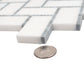 White and gray polished marble tiles arranged in herringbone mosaic pattern with smooth finish