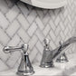 white and gray polished marble tiles arranged in herringbone mosaic pattern