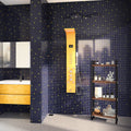 Dark blue glossy glass mosaic square tiles with gold accents on a bathroom wall