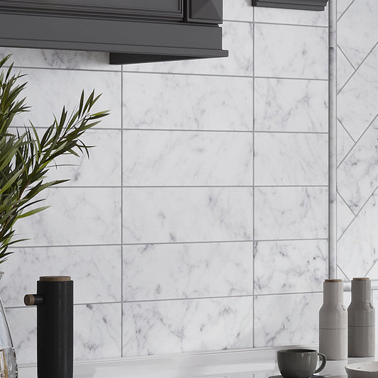 White honed Carrara marble subway tile 4x12 installed as kitchen backsplash wall