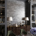 Deep gray matte ceramic subway tile, 2.5x10 inches, installed on interior wall surface