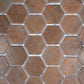 taupe matte recycled glass hexagon mosaic tile with visible grout lines in varied shades
