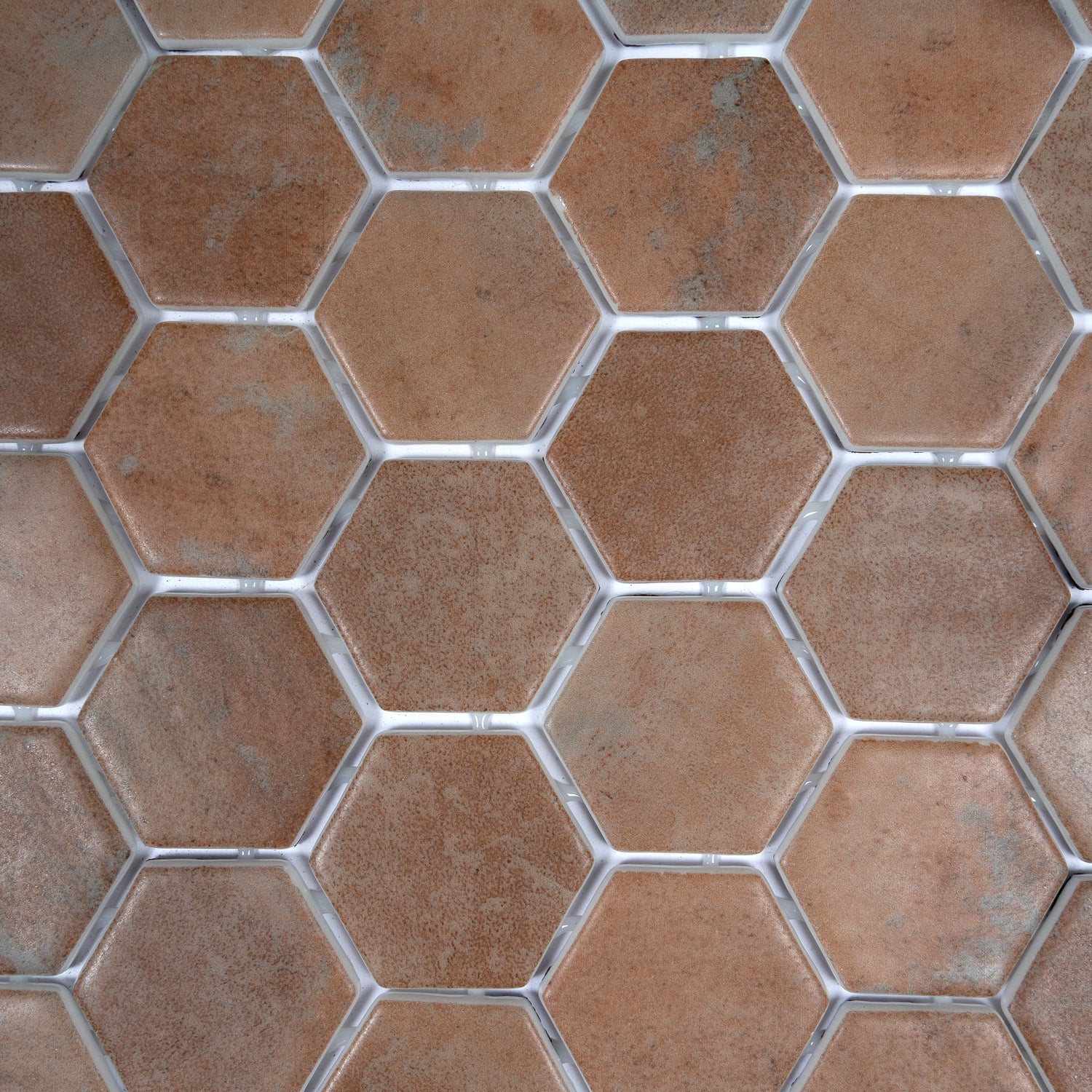 taupe matte recycled glass hexagon mosaic tile with visible grout lines in varied shades