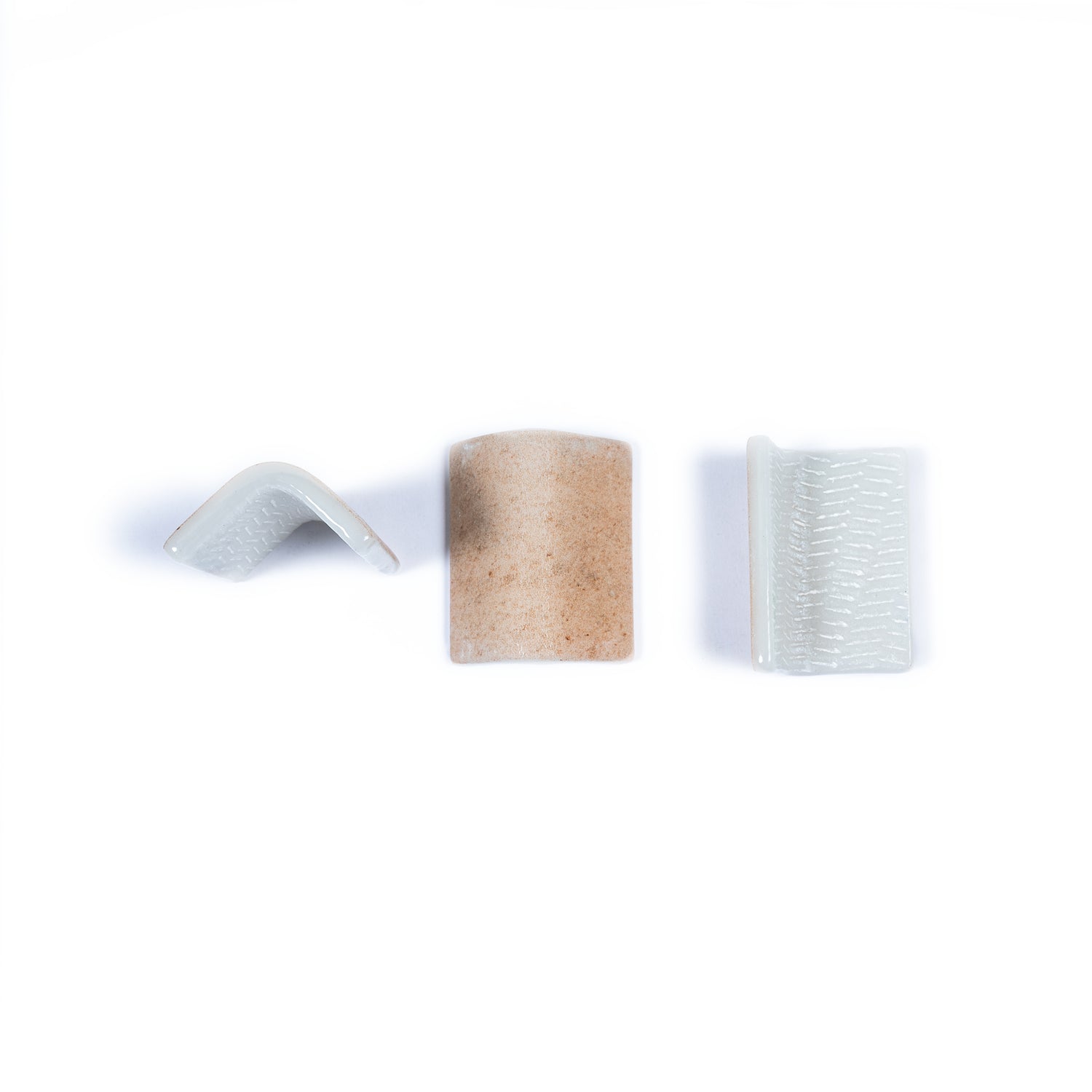 Clay beige 2x2 matte recycled glass corner tiles showing different angles and textured finishes