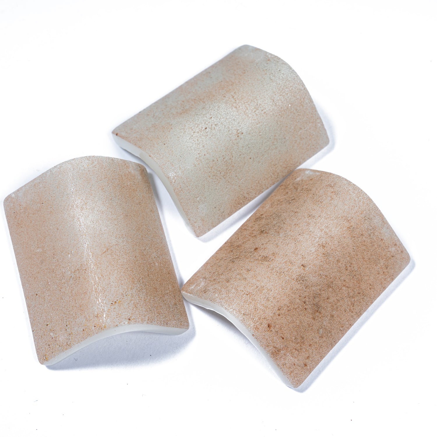 Clay beige 2x2 matte recycled glass corner tiles with textured surface in soft earthy tones