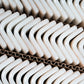 matte clay beige 2x2 recycled glass corner tiles stacked in corrugated cardboard