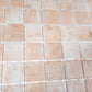 matte clay beige 12x12 recycled glass square mosaic tiles arranged in a grid