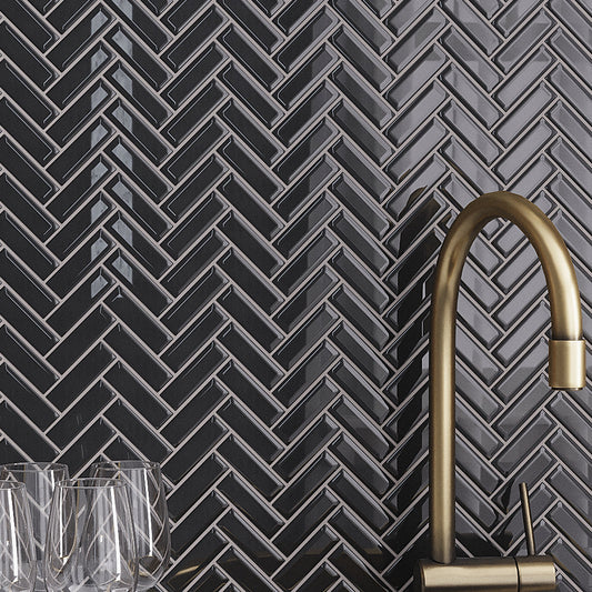 Black glossy glass herringbone mosaic tile on kitchen backsplash wall