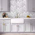 White glossy matte glass herringbone mosaic tile backsplash in kitchen setting