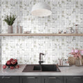 White matte porcelain 2x2 square mosaic tile backsplash with subtle beige veining