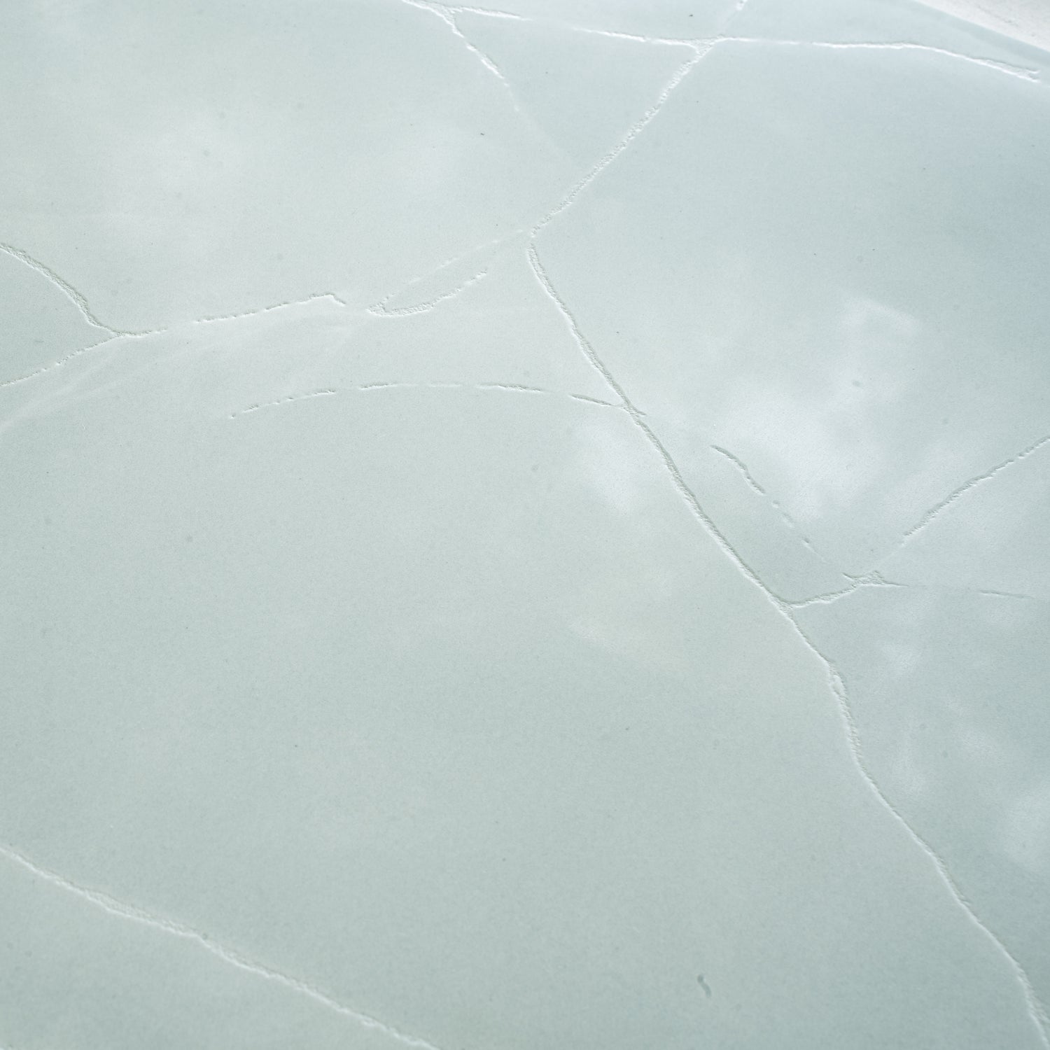 Soft jade green 24x48 honed porcelain large tile with subtle natural veining