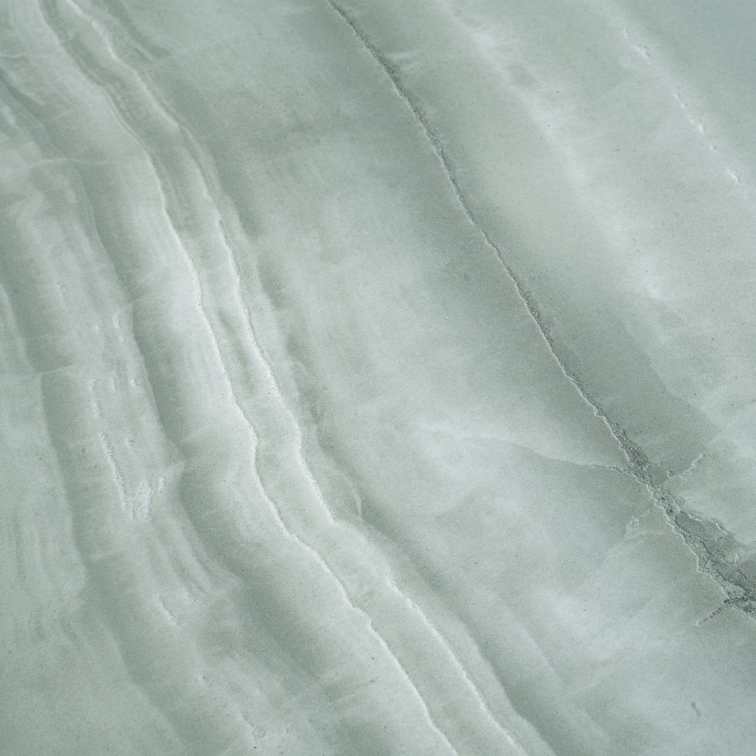 Sage jade green honed porcelain large tile with natural subtle veining and smooth matte finish
