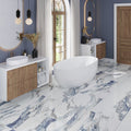 Air Superiority Blue polished porcelain large format 24x48 floor tile with marble-like veining in bathroom setting