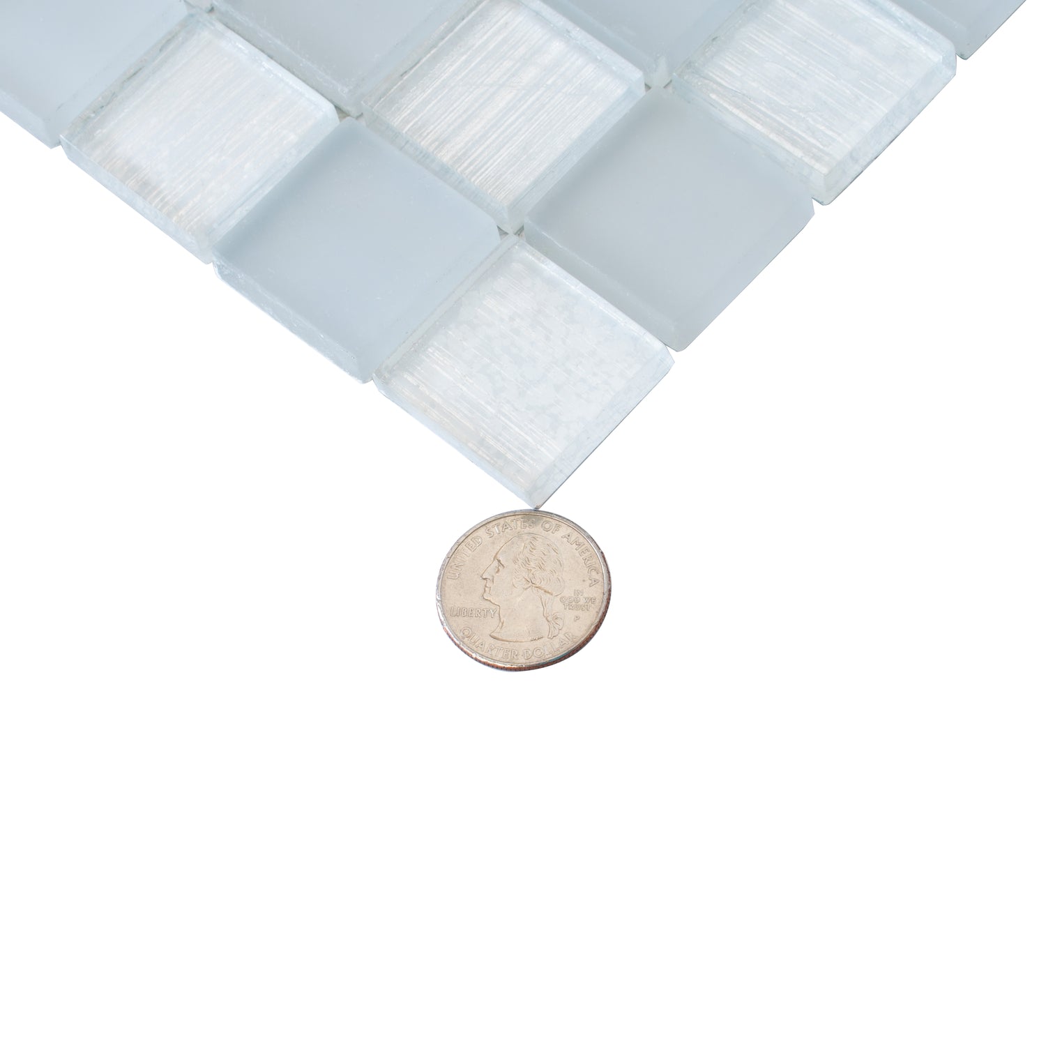 Close-up of glossy and matte gray 11x11 glass mosaic tiles in square shapes